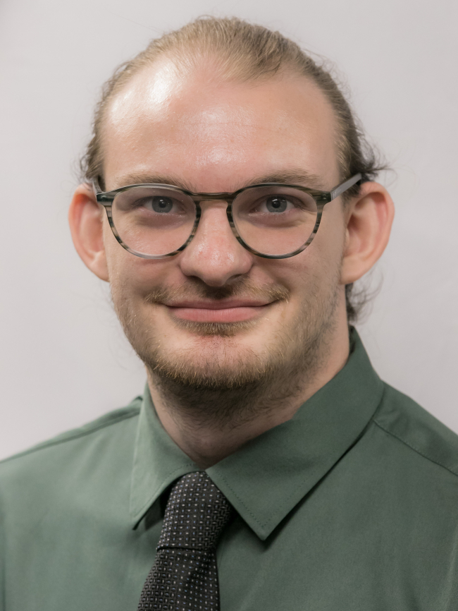 A headshot of Brett Kaufman.