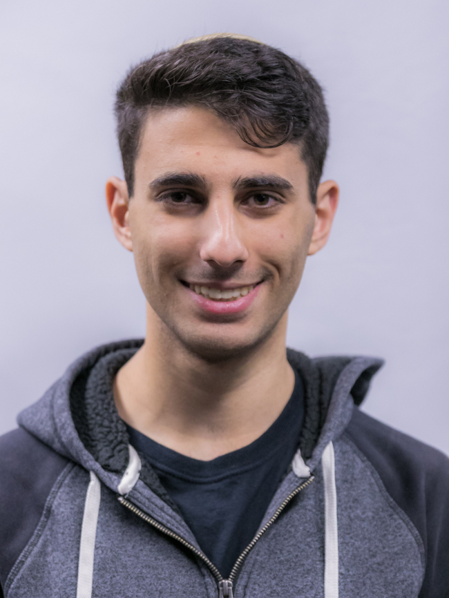 A headshot of Elisha Shmalo.