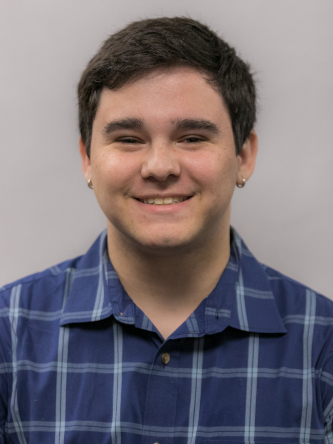 A headshot of Zachary Simms.
