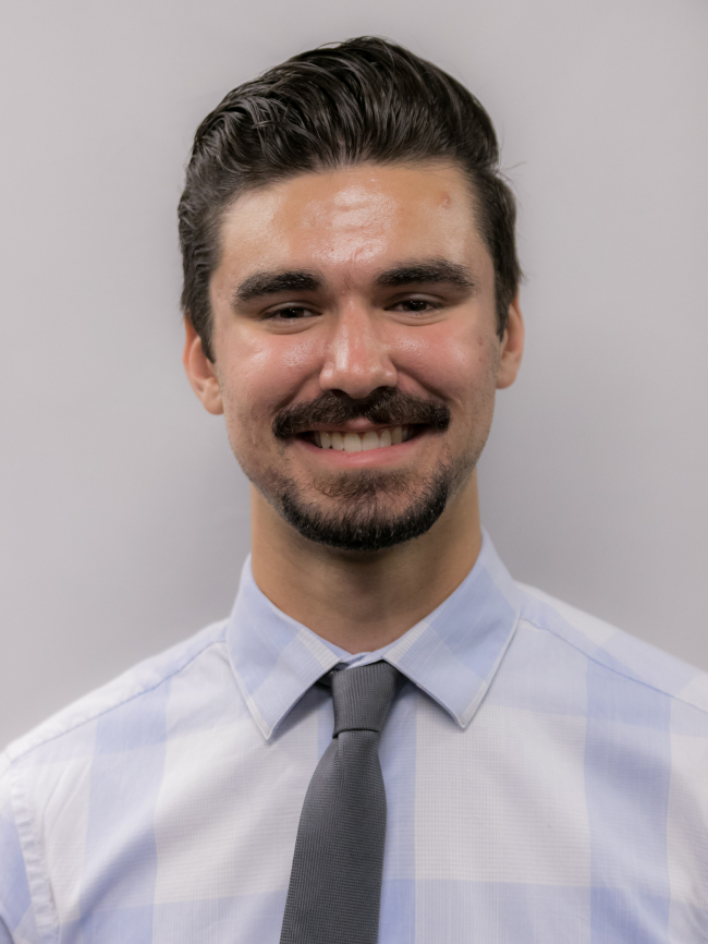 A headshot of Gregory Venarsky.