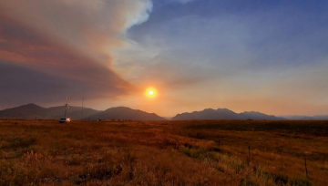 Mountain sunset over windmill