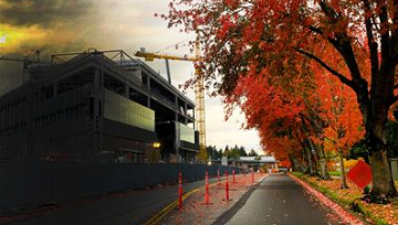 Building construction next to fall color on trees