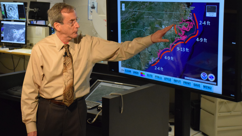 In a live television briefing, NHC Deputy Director Dr. Ed Rappaport emphasizes the expected life-threatening storm surge heights from Hurricane Florence. This message would be repeated continuously during Florence and Michael.