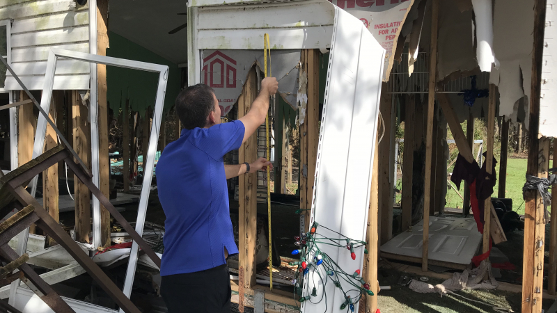 NHC Storm Surge Specialist Jamie Rhome measures the impact of storm surge onto a heavily damaged home in New Bern, North Carolina. Sept. 26, 2018.