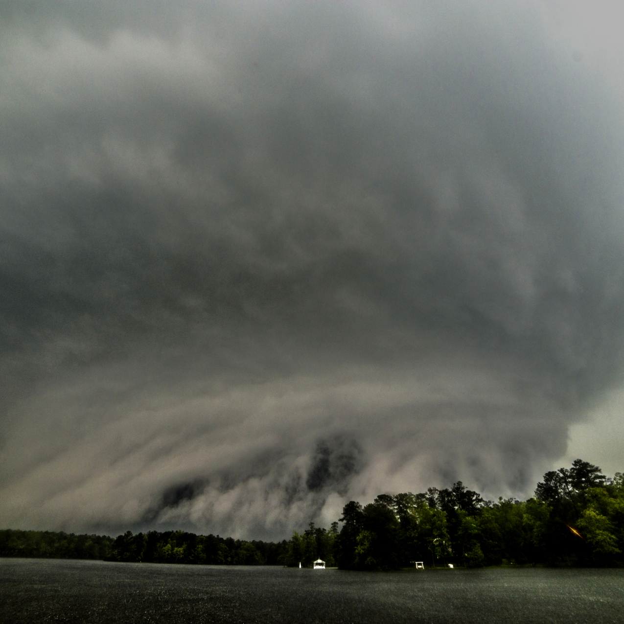 Looking southwest at a supercell with a thunderous tornado in progress asit approaches Lake Tiak-O-Khata