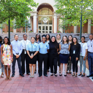 Students pose for a group photo outside NOAA headquarters.