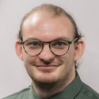 A headshot of Brett Kaufman.