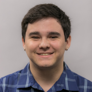 A headshot of Zachary Simms.