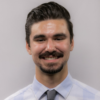 A headshot of Gregory Venarsky.