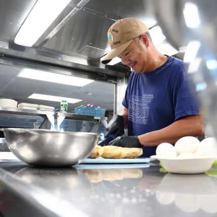 Photo of Arnold Dones, the chief steward, or chef, aboard NOAA Ship Reuben Lasker, prepares a delicious meal for the ship’s crew and scientists.
