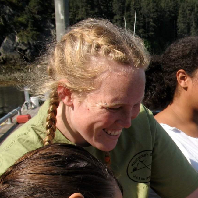 Kaitlin assists several high school students empty a plankton sampling net into a sampling container.